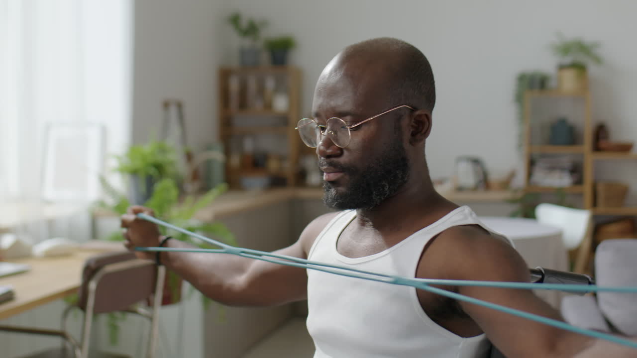 African American Man with Disability Training with Resistance Band
