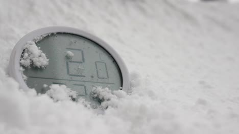 digital thermometer buried in fresh snow