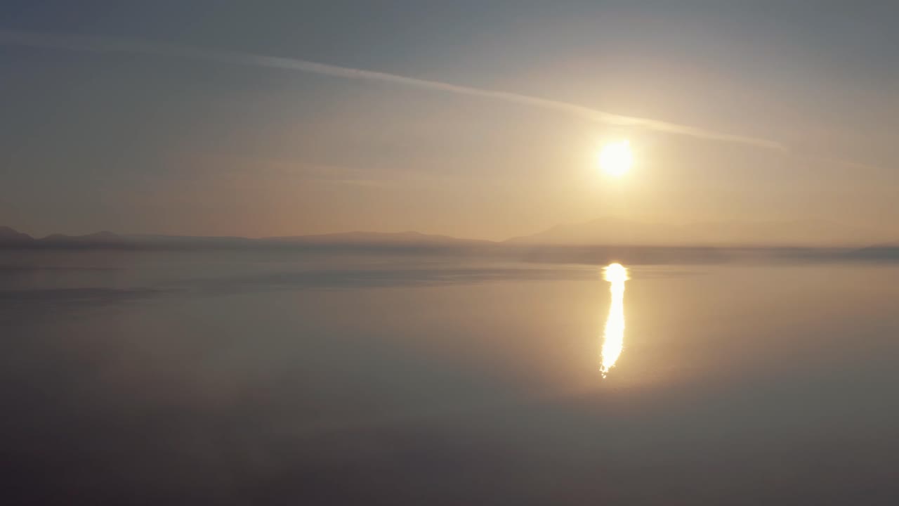Aerial Static View Of Golden Yellow Sunset Above Misty Lake