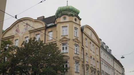 old buildings above electric tram cables on wiener platz square, munich germany