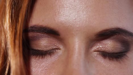 close-up of a woman with makeup and green eyes