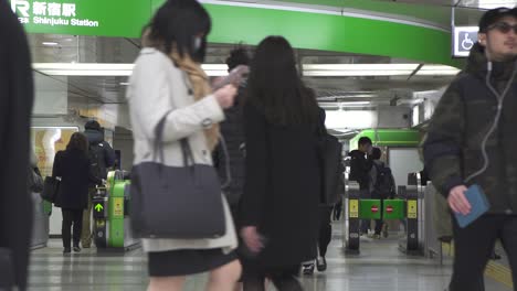 commuters in shinjuku train station tokyo