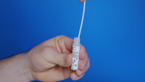 Vaginal-swab-sample-put-in-dropper-bottle-with-extractions-of-antigens-and-mix-it-clockwise