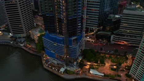 descending aerial view of 443 queen street building being built, brisbane, australia