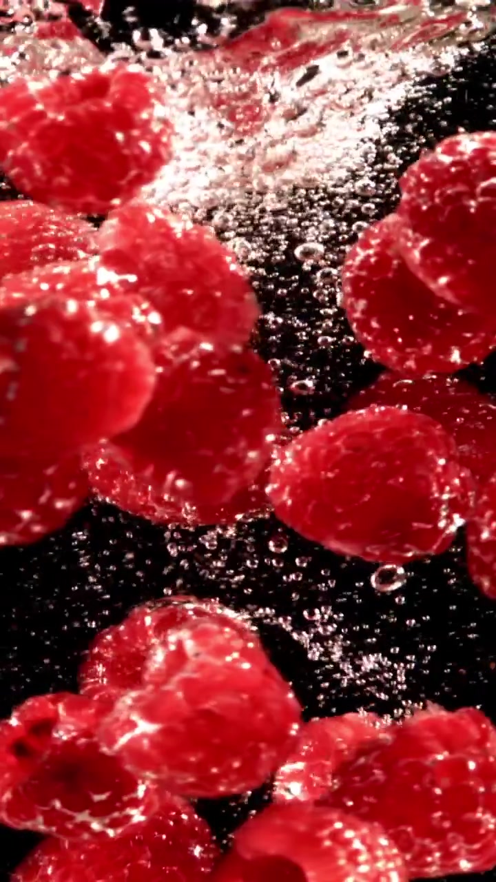 Fresh Raspberries Submerged in Water with Effervescent Bubbles
