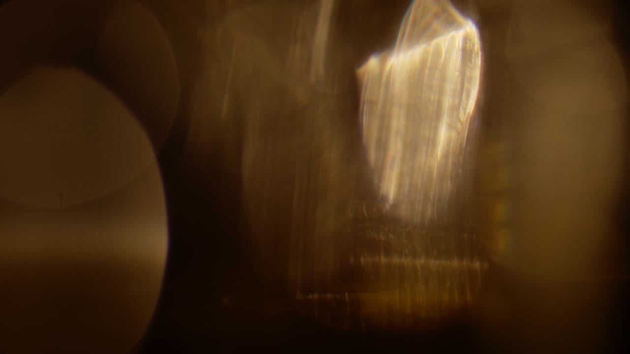 Multicolored light leaks 4k footage on black background. Stylizing video, transitions. Bokeh effect