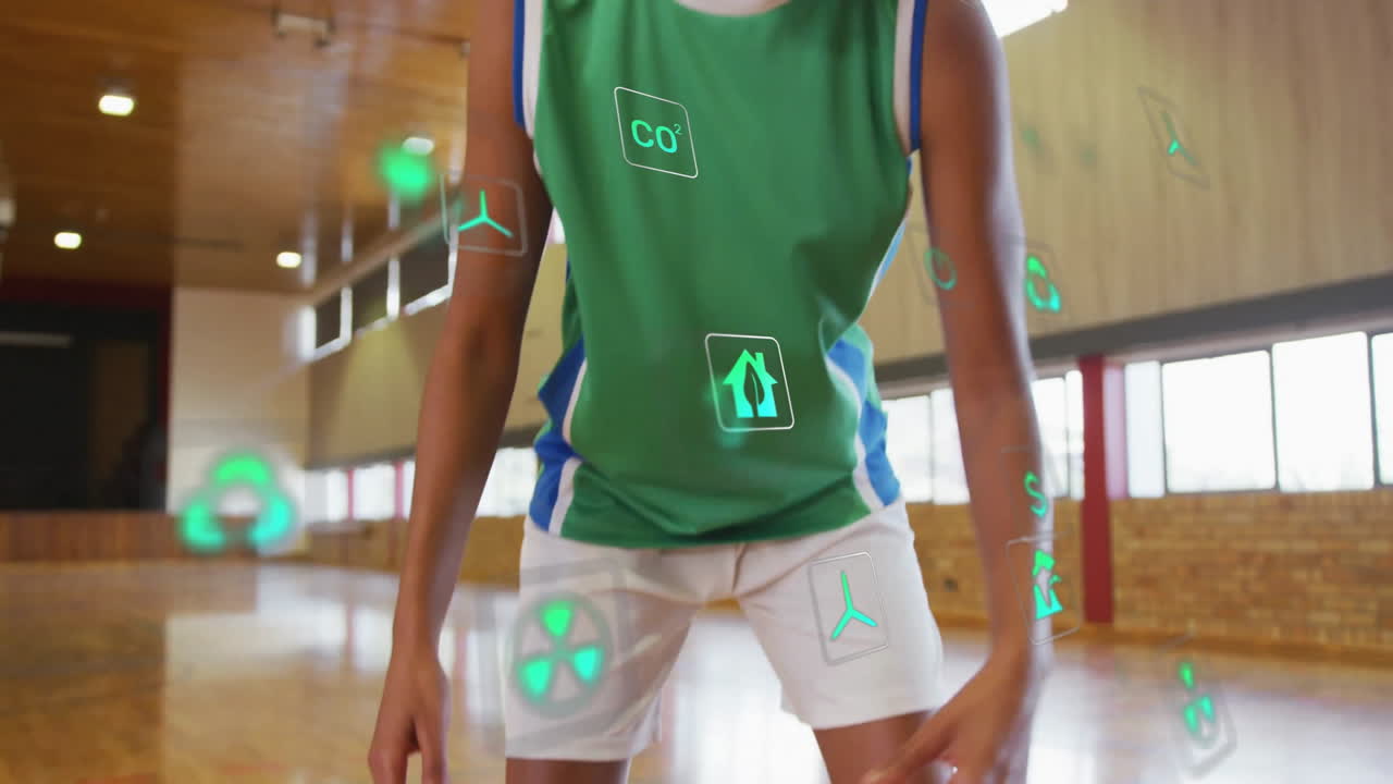 Dribbling basketball, player in gymnasium with animation of digital data icons