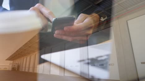 Animation-of-man-using-smartphone-over-warehouse-in-background