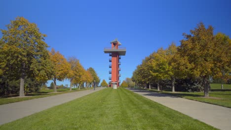 a man walks away from a lookout tower at a city park