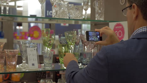 man taking a shot of glass in the store