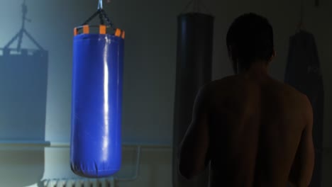 man training in the gym with punching bag