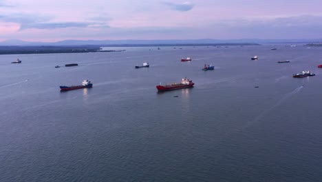 oil tankers and lpg ships sailing across the sea near port of balikpapan in kalimantan, indonesia