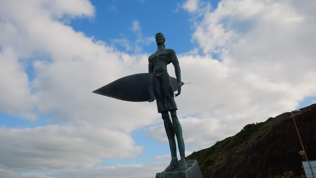 wide shot of the Statue of a surfer in the beach of Ribeira d’Ilhas World Surf Reserve, Oeste region, Portugal