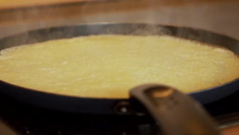 pancake in a frying pan. close up, slow motion.