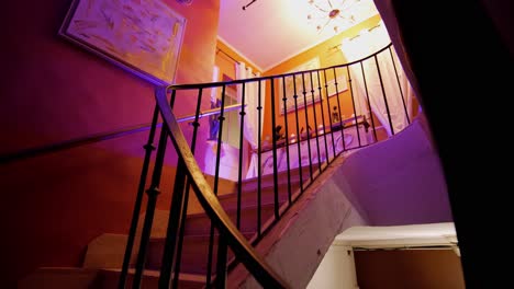 scenic indoor view of stairs with colorful lights on the first floor
