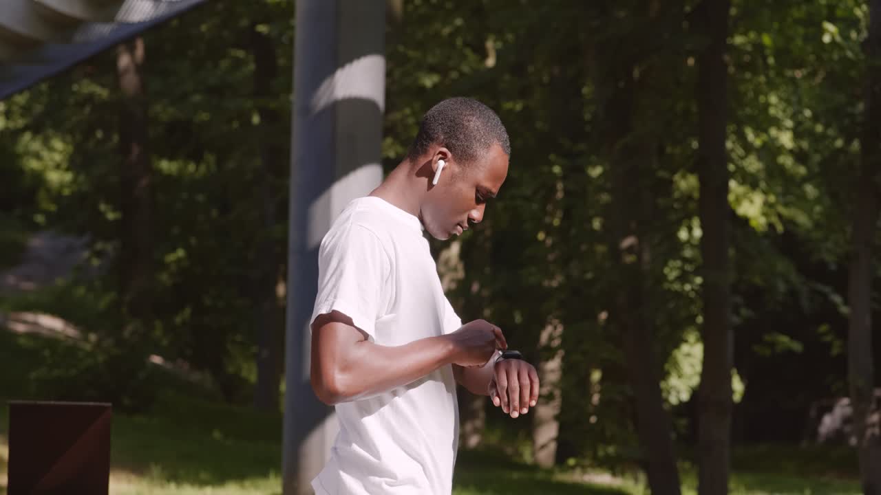 Man Checking Smartwatch in Park