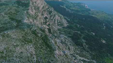 dramatic steep mountain range biokovo on croatian coastline, aerial tilt up