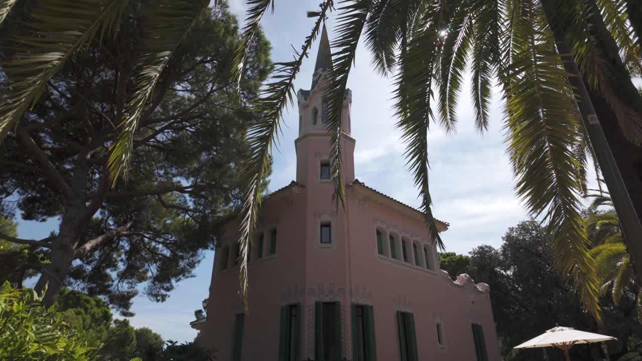 Establishing tilt down of Gaudí House Museum in Park Güell, showcasing its unique modernist style