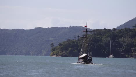 old sailboat with toursist sailing in bay of paraty, brazil