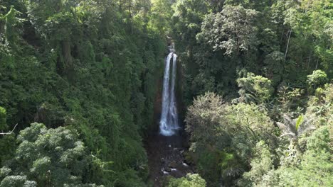 gitgit waterfall with jungle surroundings on a sunny day in bali, indonesia