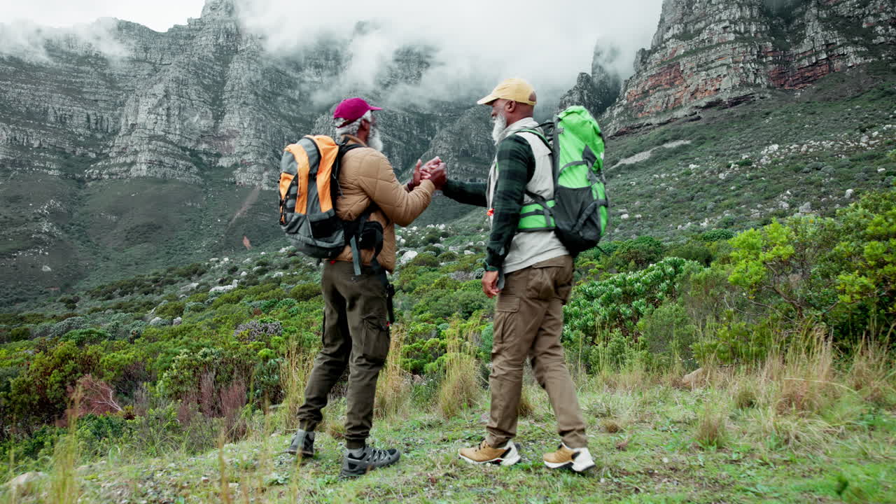 Two elderly men hiking in the mountains