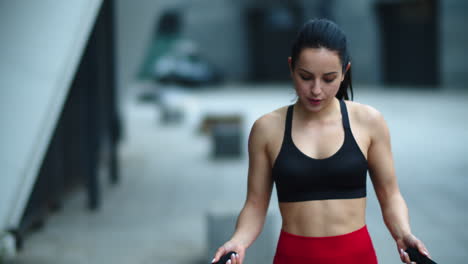 Closeup-fit-woman-jumping-on-skip-rope-outdoor.-Tired-woman-finishing-exercise