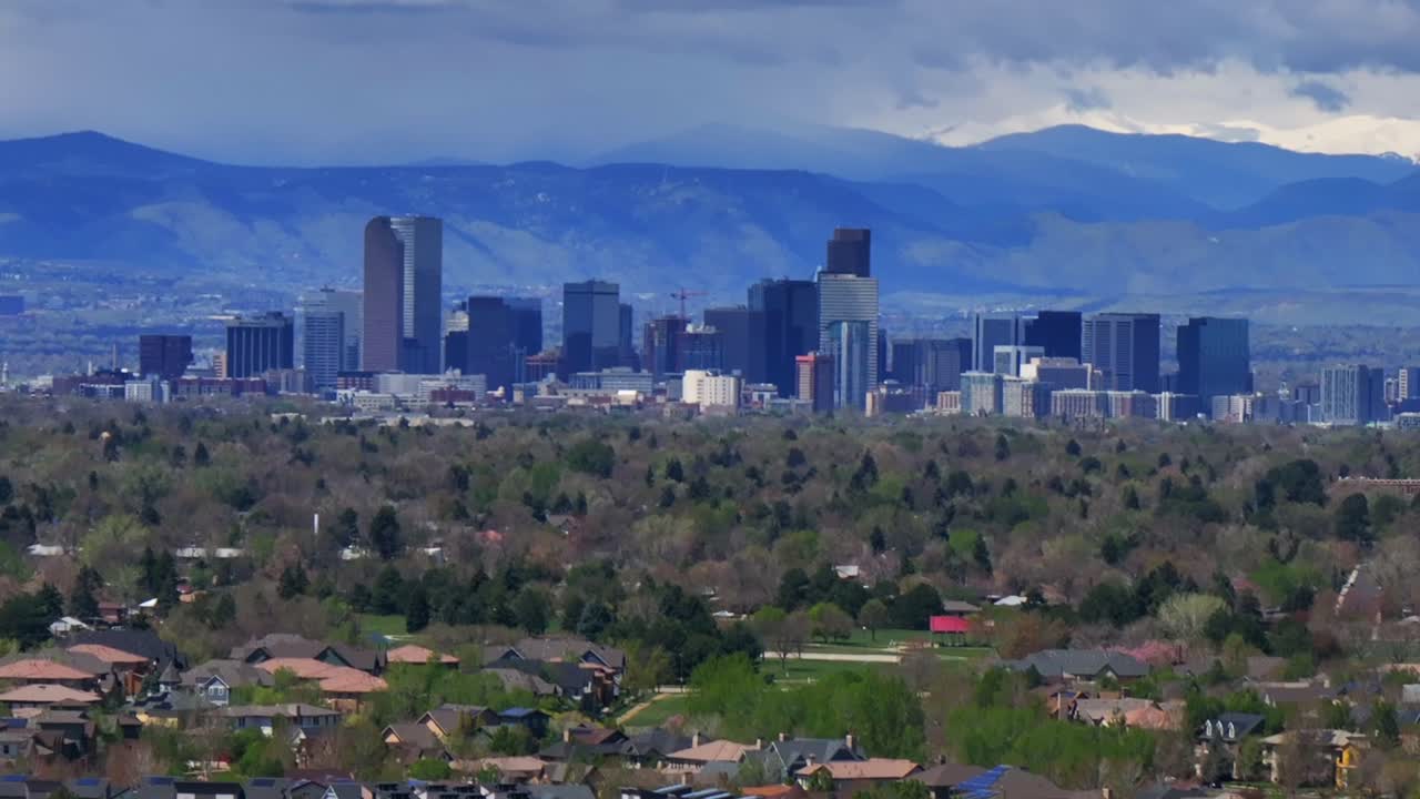 Downtown Denver skyscraper front range foothills landscape view aerial drone Colorado Northfield Stapleton Central Park spring morning rain clouds sunny cityscape Capitol building forward zoom in