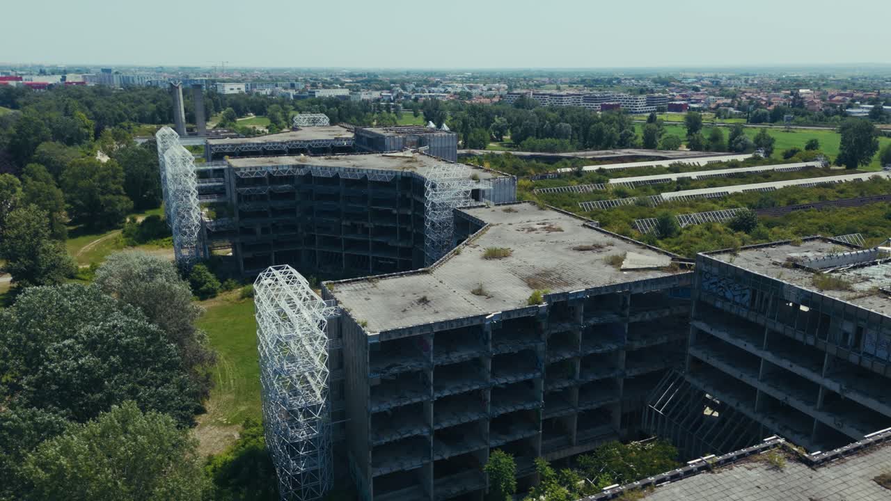 aerial - abandoned hospital in Blato Zagreb overtaken by vegetation with visible metal framework