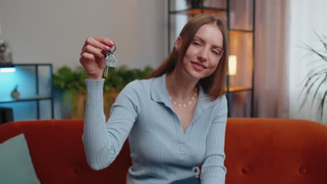 woman real estate agent showing the keys of new home house apartment, buying or renting property