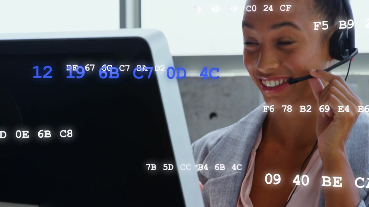 Call center agent adjusting mic, speaking, helping caller, with hex overlay over monitor, face