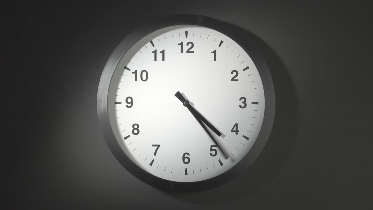 Clock Face in Time Lapse on Dark Grey Wall