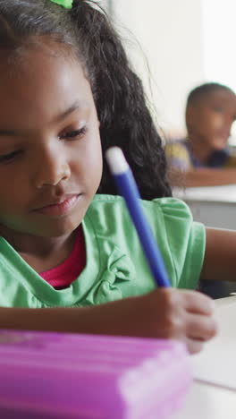 video of focused african american girl doing lessons in classroom