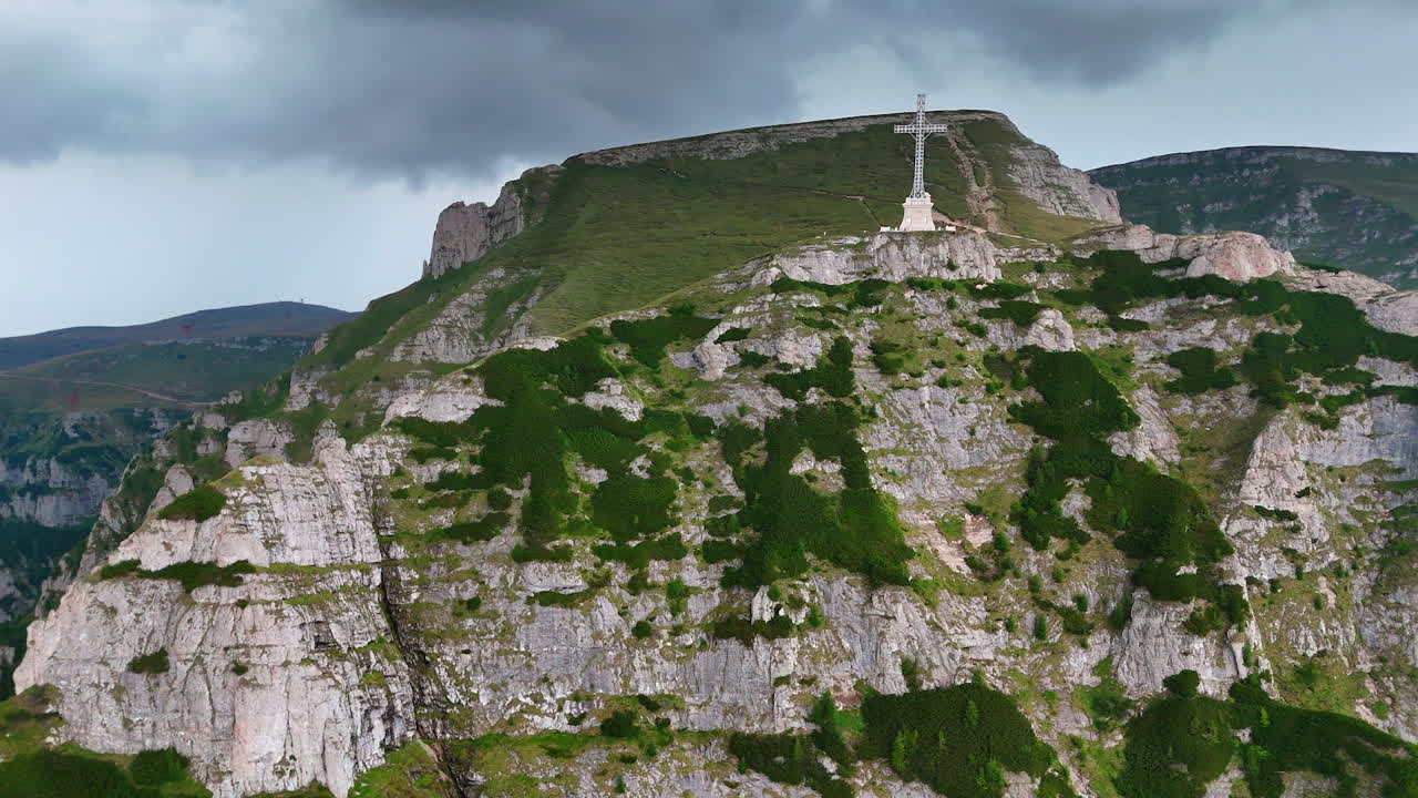 Monumental cross on Caraiman Peak in Bucegi Mountains. The Heroes' Cross monument standing tall on Caraiman Peak in the Bucegi Mountains