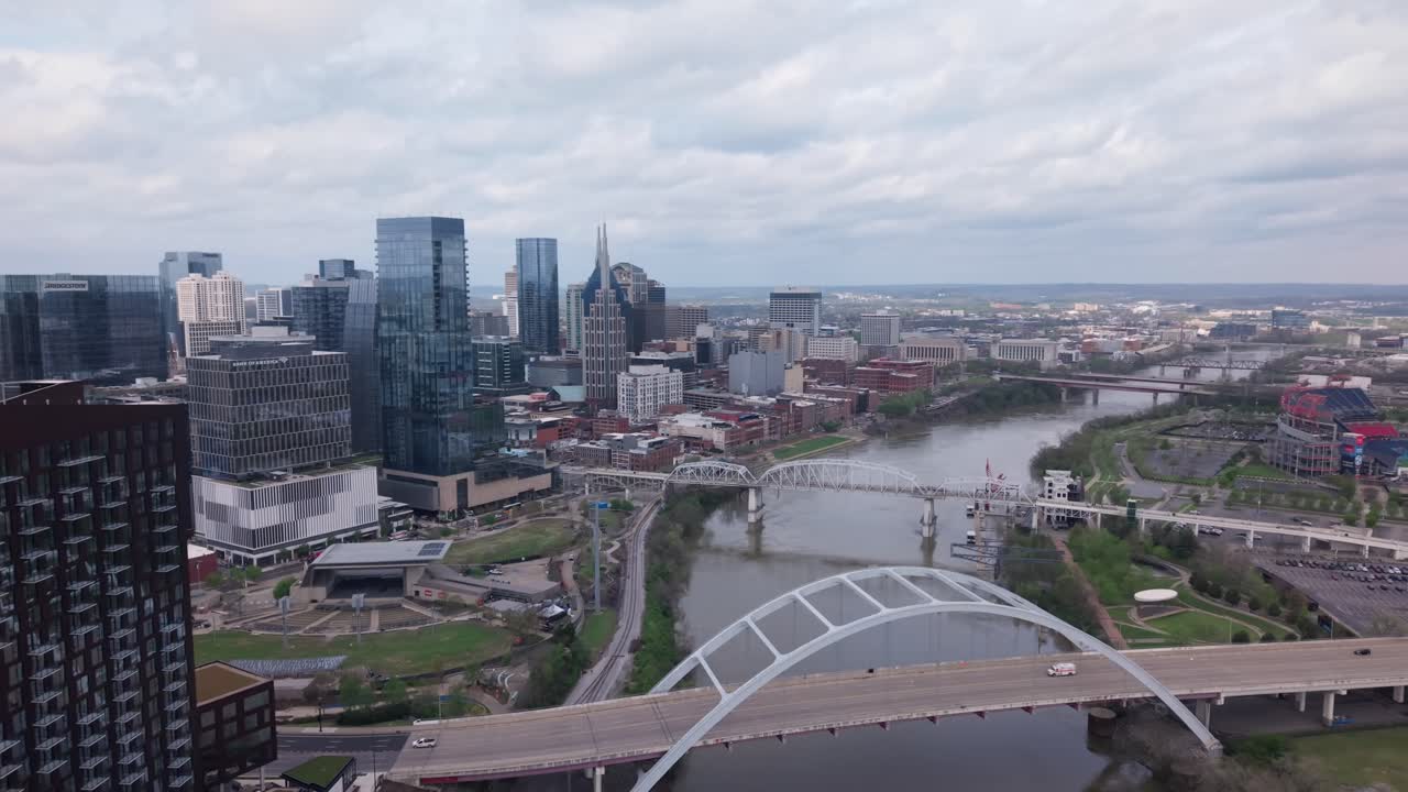Aerial view of Cumberland River winding through downtown Nashville, Tennessee, with stunning views of Music City's iconic bridges and skyline