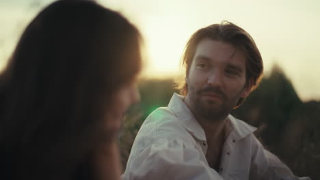 man in white shirt outdoors at sunset