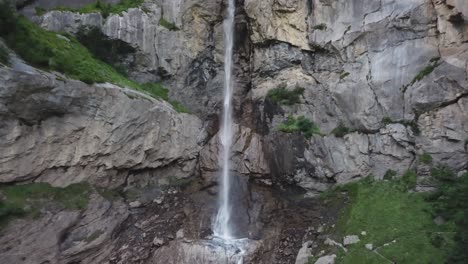 Wide-shot-of-waterfall-Almenbachfall-Berner-Oberland-Switzerland-drone-flight