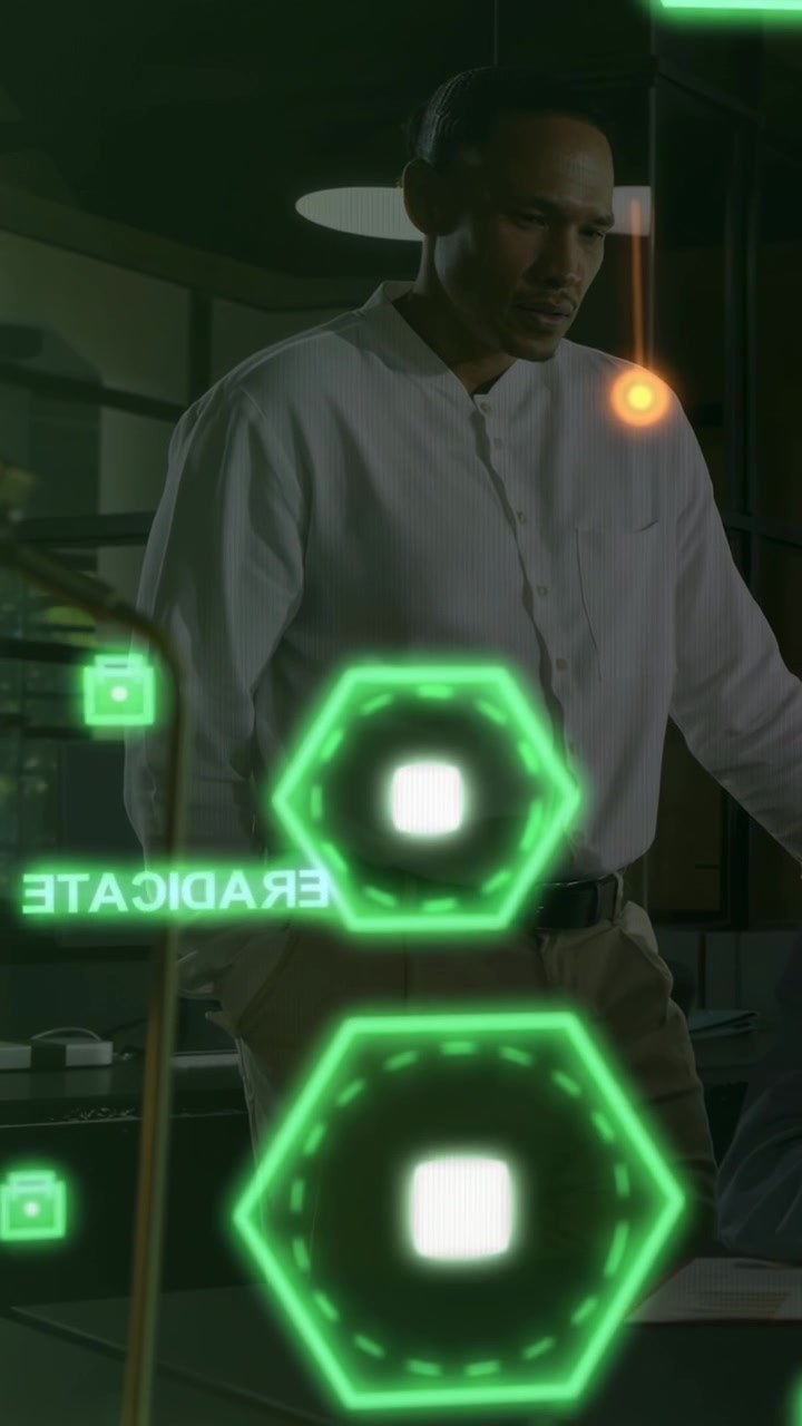 Vertical video: Man at desk checking data on tech UI after orange orb triggers green hexes on glass