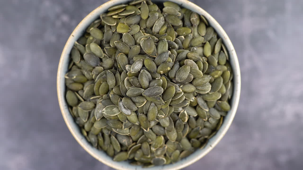 Healthy Organic Pumpkin Seeds, Macro Close-up Of Pumpkin Seeds In Bowl, Healthy Vegetarian Vegan Raw Food