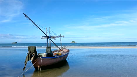 4k shot,fishing boats are parked on the beach with blue waters and blue skies on tropical landscapes.
