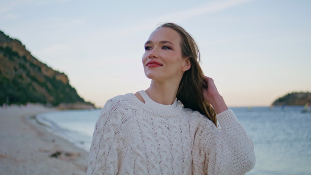 Serene girl walking beach at evening closeup. Happy woman exploring