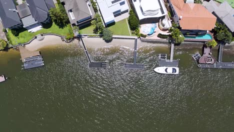 aerial view of mansions, pools, and boats