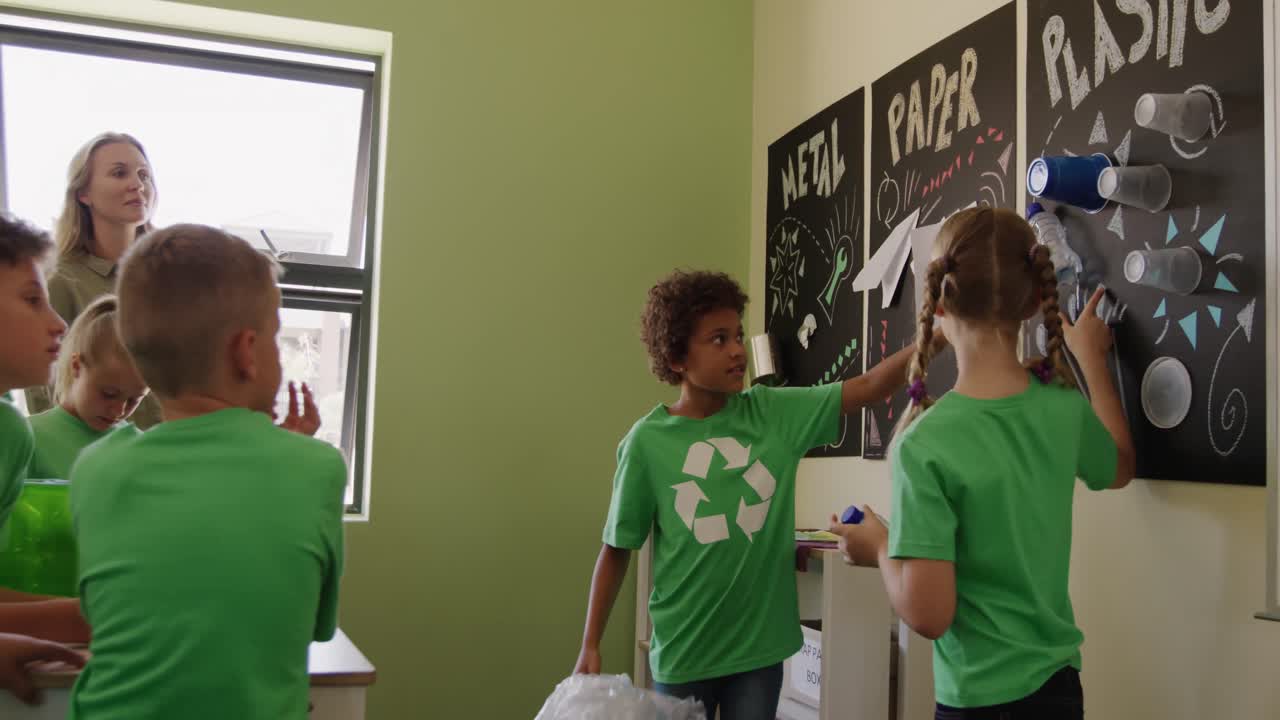 Two girls wearing recycle symbol tshirt holding plastic bottle and bag
