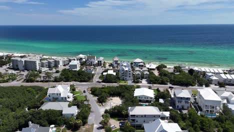 forwardly upwards drone movement over the coastal luxury residential and suburban area overlooking turquoise water, 30a, florida, usa
