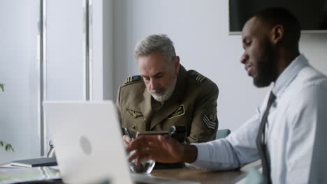 general giving orders to worker