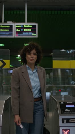 woman walking through a subway station gate