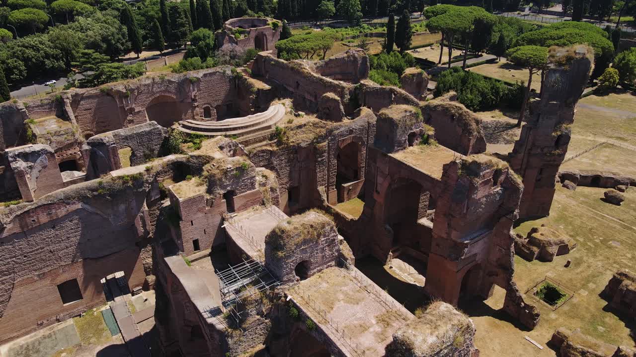 Sunny aerial of Caracalla ruins shows decayed walls and historic amphitheater