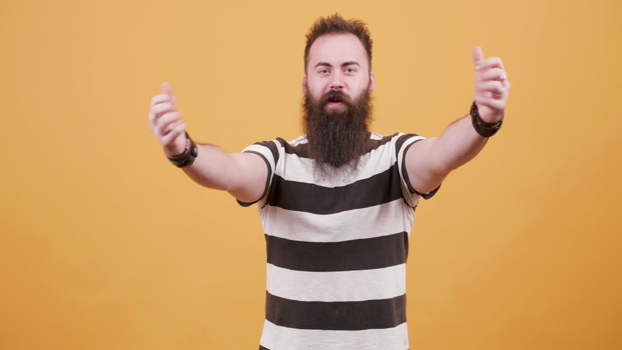 Bearded man celebrating with positive gestures