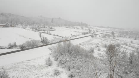 Aerial-view-of-snow-covered-country-road