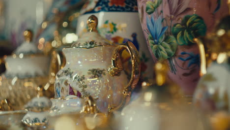 vintage porcelain tea sets in antique shop - close up