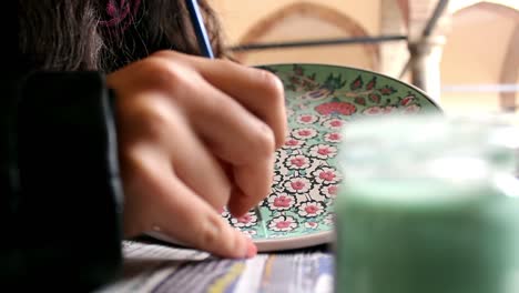 artist painting traditional ottoman tile porcelain motifs